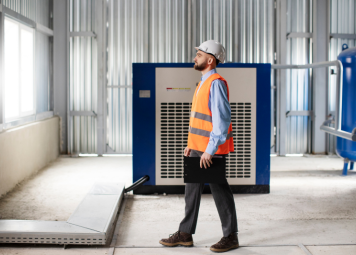 HVAC engineer inspecting chiller unit rooftop Dubai Eagles Crew Technical Services