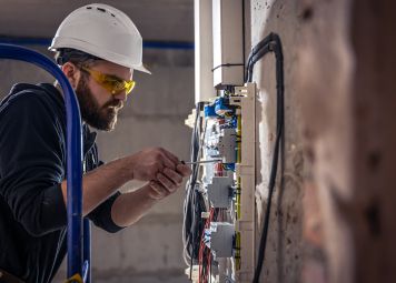 Professional plumbing contractor inspecting drainage pipes in Dubai residential building