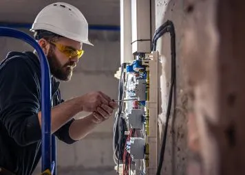 Professional plumbing contractor inspecting drainage pipes in Dubai residential building