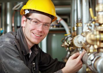 Licensed plumber repairing water pipe leak in commercial property Dubai