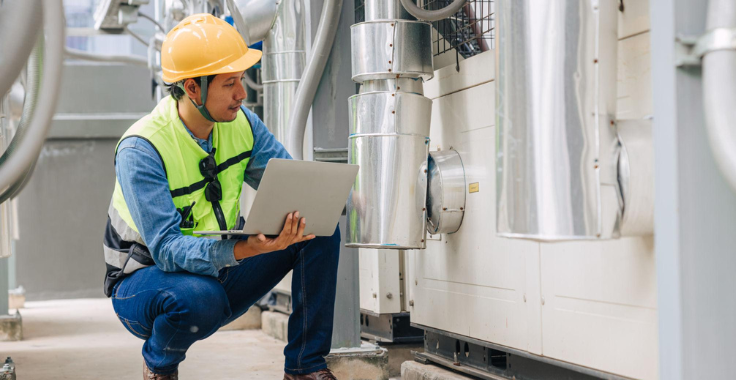 Professional HVAC technician installing a commercial heating and cooling system